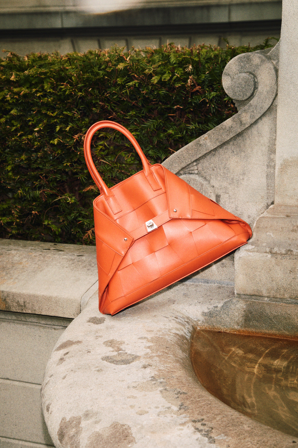 Small Leather Crossbody Handbag with Braided Trapezoids - orange